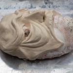 A mask sculpted from oil clay