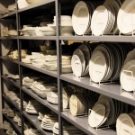 A shelf of dinnerware from Martha's prop shop