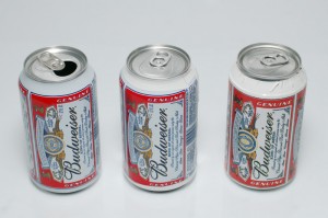 A real can, and two prop cans with fake labels