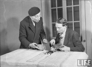 Edmond Beauvais, prop master, prepares a removable hand with the actor