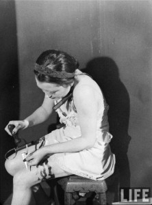 Simone GÃ©rard demonstrates a trick knife. Photograph by Hans Wild, 1947