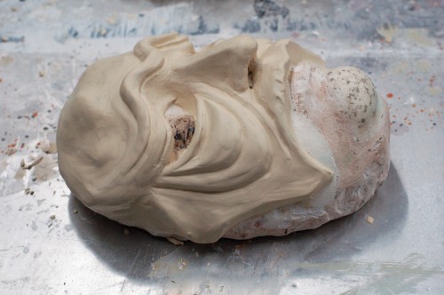 A mask sculpted from oil clay